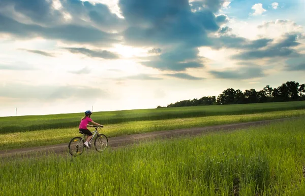 Mädchen auf dem Fahrrad in ländlicher Landschaft — Stockfoto