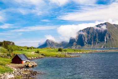 Scenic fjord Lofoten islands typical fishing hut clipart