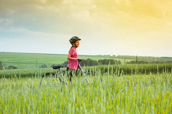 Kız kırsal manzara bir bisiklet üzerinde — Stok fotoğraf
