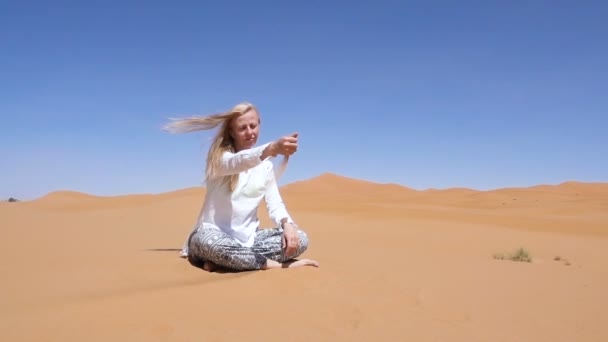 Blonde Frau in Wüste gießt Sand Meditation Entspannungskonzept — Stockvideo