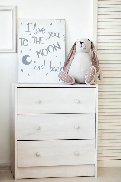 Soft toy lop-eared rabbit on the dresser. Close-up — Stock Photo, Image