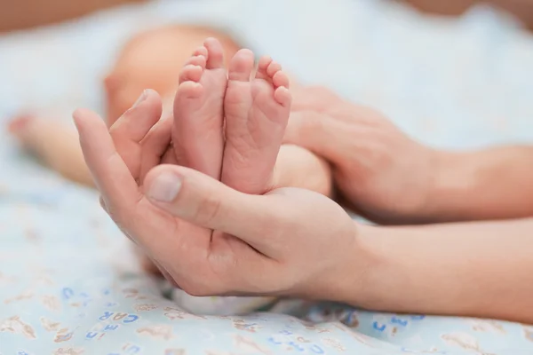 Tiny feet of a newborn on the hand of the Pope. Close up. — Stock Photo, Image