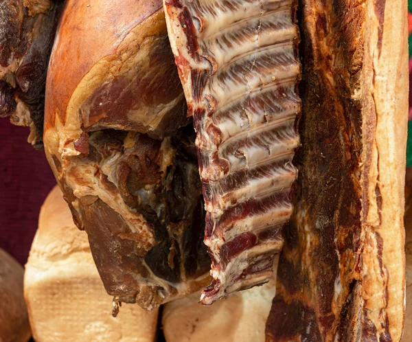 Smoked ribs, smoked ham hanging in smokehouse