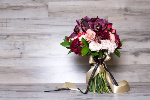 wedding bouquet, the beautiful floral arrangement, on the shabby wooden table