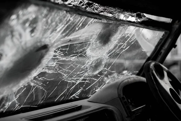 Bullet hole on a car windshield. Car window after a raid has a bullet hole. Broken glass. Bullet holes in a front windshield. Broken Windshield