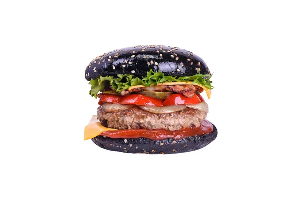Black burger with pork and beef meat, bacon, cheddar, pickled cucumber, bulgarian pepper, grilled onion, salad mix, special sauce isolated on a white. — Stock Photo, Image
