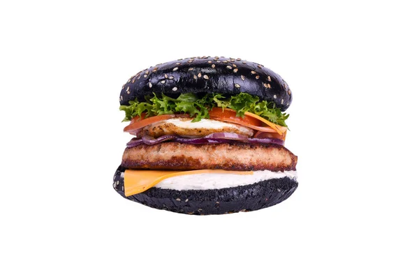 Black burger with chicken meat, ham, chicken egg, feta, cheddar, grilled tomato, bell pepper, caramelized onions, salad mix isolated on a white. — Stock Photo, Image