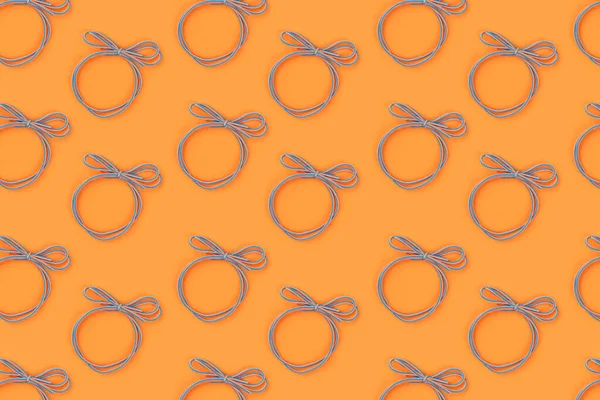 Bright blue-orange elastic band for hair on an orange background