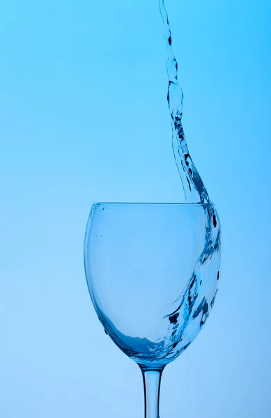 glass of water on a pink background