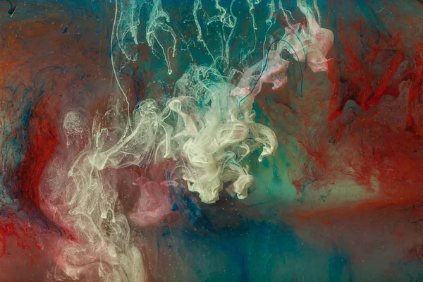 Color paint drops in water. Ink swirling underwater.