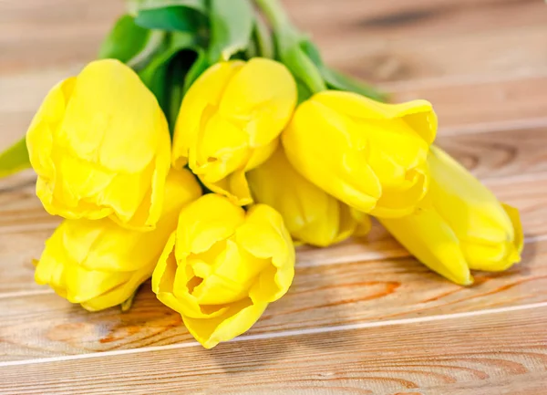 Tulipanes amarillos flores, fondo madera — Foto de Stock