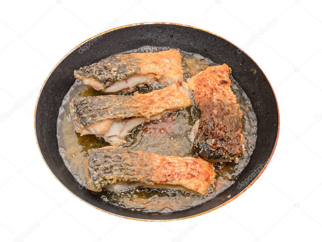 Carp fish meat fried in oil, crispy look, cooking pan close up
