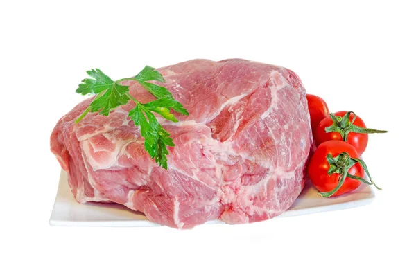 Pork raw meat on a white plate, decorated with green parsley — Stock Photo, Image
