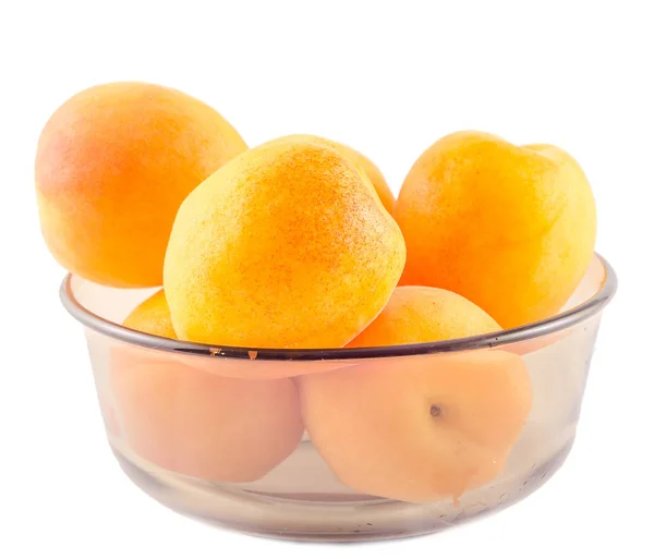 Yellow orange apricots in transparent vase, isolated background, — Stock Photo, Image