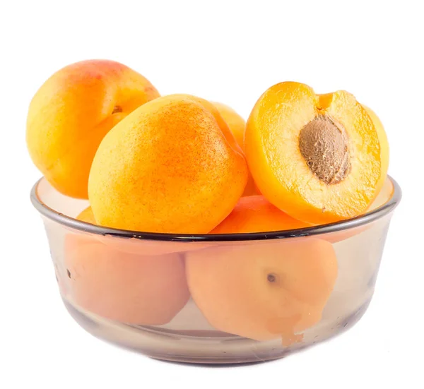 Yellow orange apricots in transparent vase, isolated background, — Stock Photo, Image