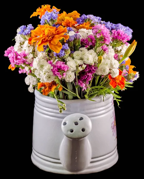 White ceramic watercan, sprinkler, with vivid colored flowers