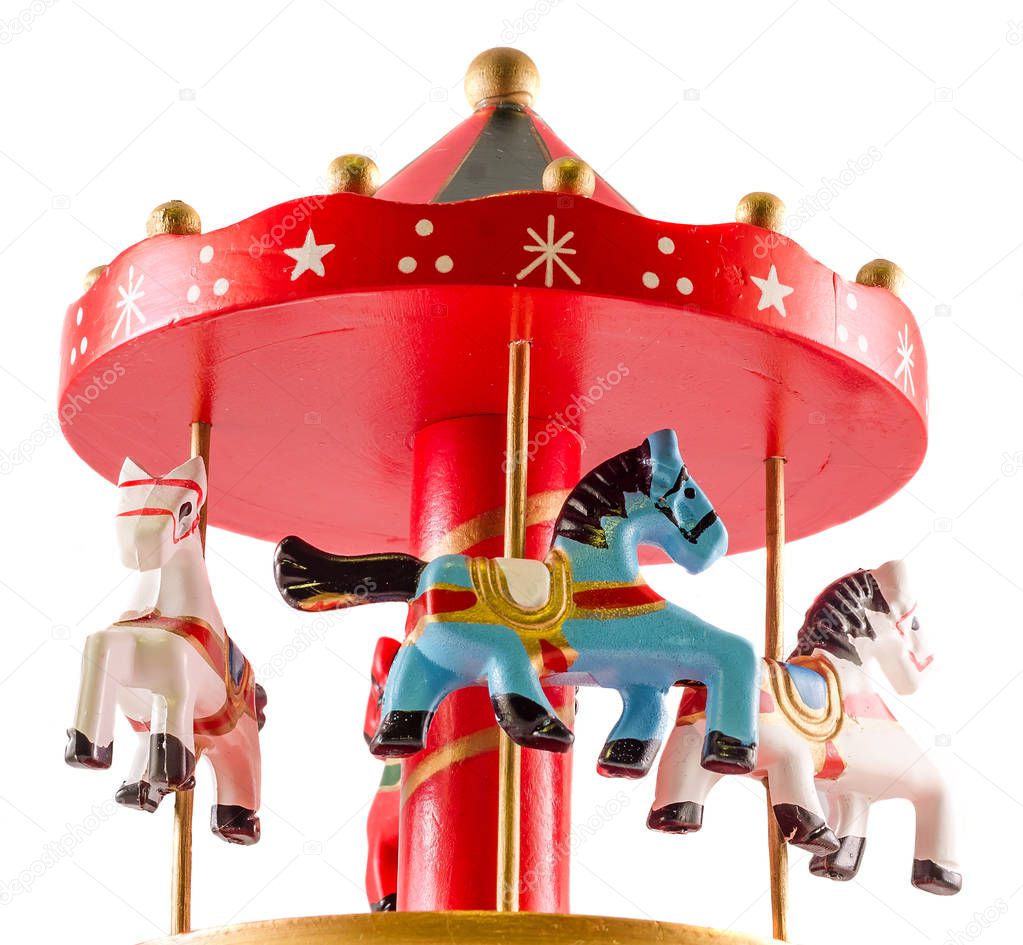 Colored carousel toy with horses, close up, isolated, white back