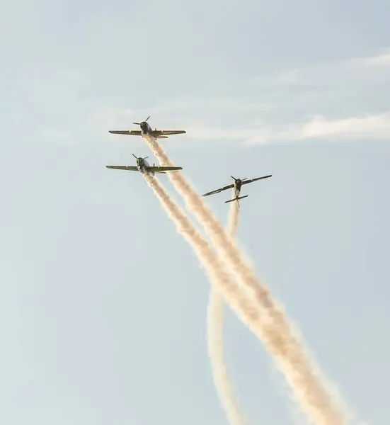 Şehrin gökyüzünde eğitim akrobasi uçak pilotları. İzleme duman ile renkli uçak. — Stok fotoğraf