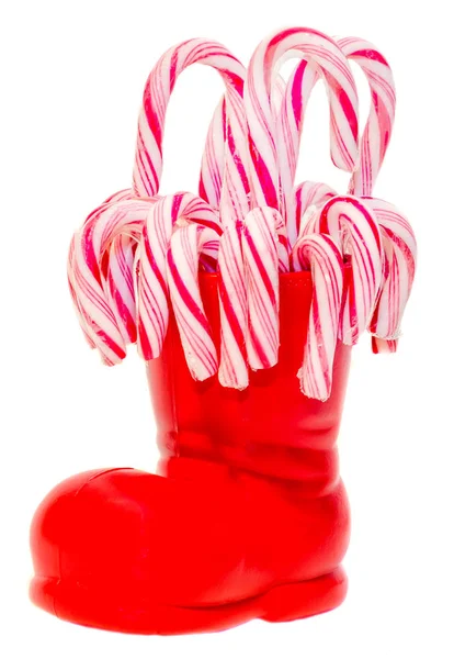 圣诞老人的红靴子，鞋用彩色的甜棒棒糖，糖果 — 图库照片
