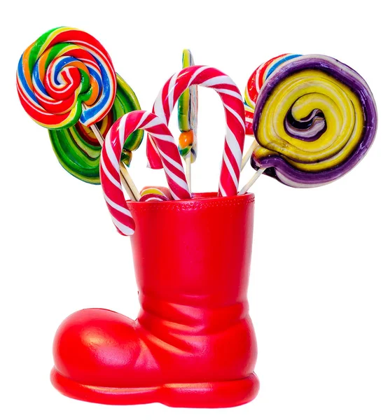 Santa Claus red boots, shoes with colored sweet lollipops, candy — Stock Photo, Image