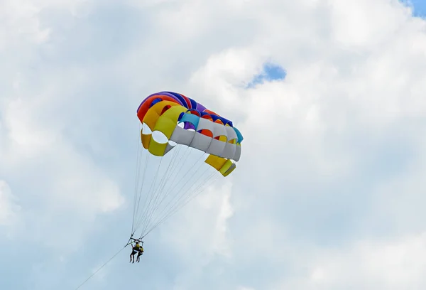 Colored parasail wing in the blue clouds sky, Parasailing — Stock Photo, Image