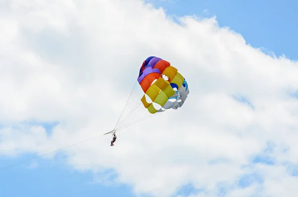 Colored parasail wing in the blue clouds sky, Parasailing — Stock Photo, Image