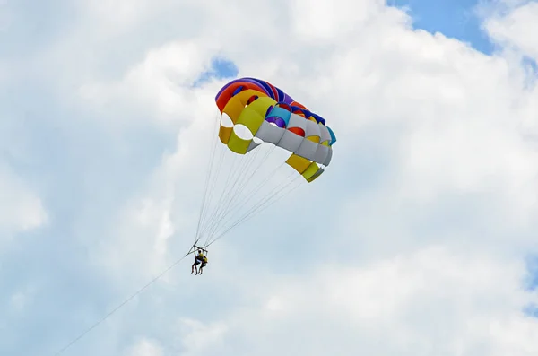 Colored parasail wing in the blue clouds sky, Parasailing — Stock Photo, Image