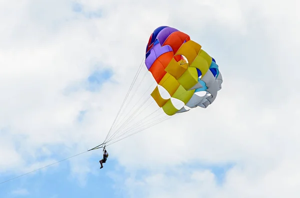 Colored parasail wing in the blue clouds sky, Parasailing — Stock Photo, Image