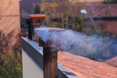Smoking chimney of an house clipart