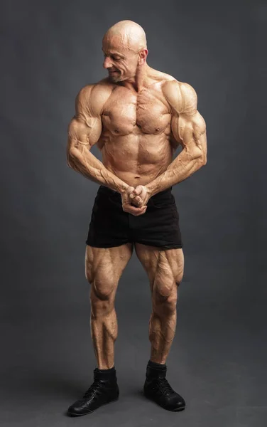 Atleta en pose delantera. Culturista mostrando músculos y motivando al entrenamiento — Foto de Stock