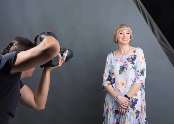 Photographer works with a client in the studio