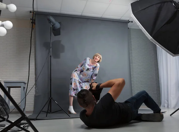 Photographer works with a client in the studio