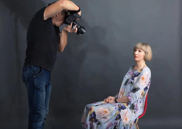 Photographer works with a client in the studio