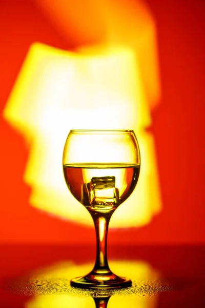 A glass with a drink on a beautiful red background illuminated w — ストック写真