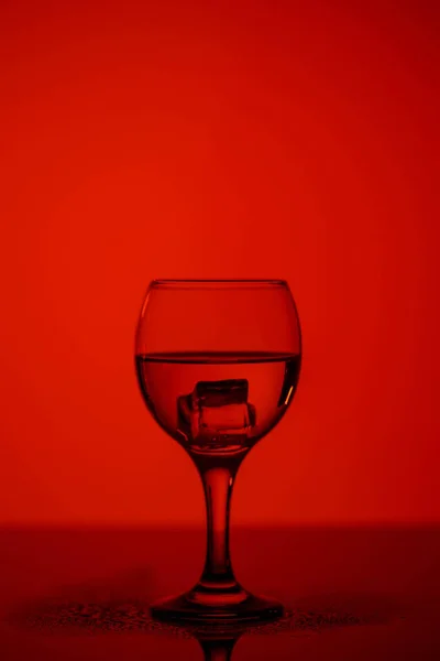 Szampan szklanka na czerwonym pięknym tle na czarnym szkle — Zdjęcie stockowe