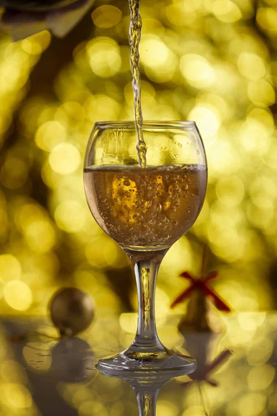 champagne glass on gold background with beautiful bokeh and Chri