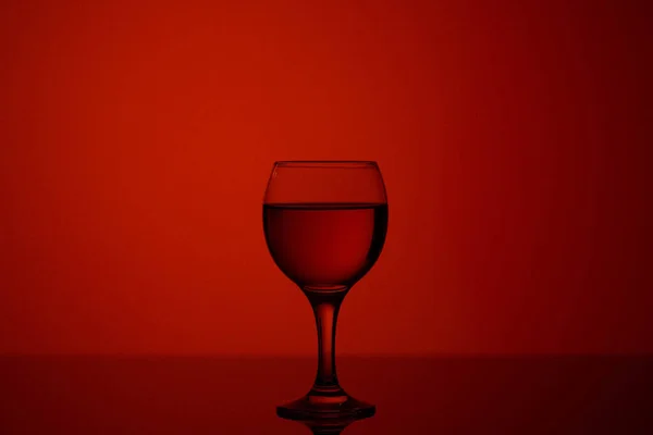 Champagne glass on red beautiful background on black glass — ストック写真