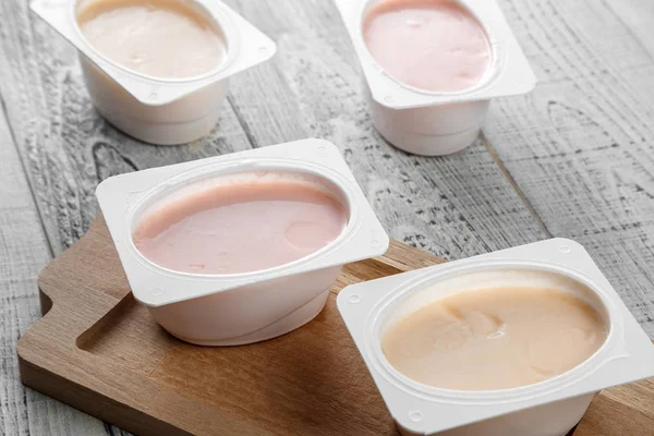 Natural organic yogurt of different types on a wooden background — ストック写真