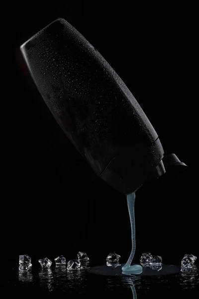 Czarny spocony plastikowy butelka do szamponu lub żel pod prysznic, z którego — Zdjęcie stockowe