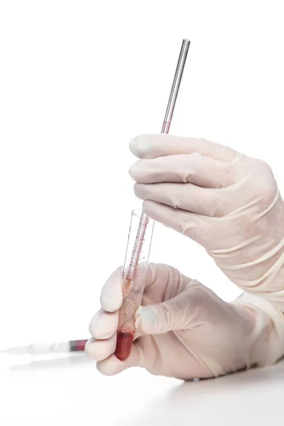 Hand of laboratory assistant holding test tube with blood sample on white background. Stock Image