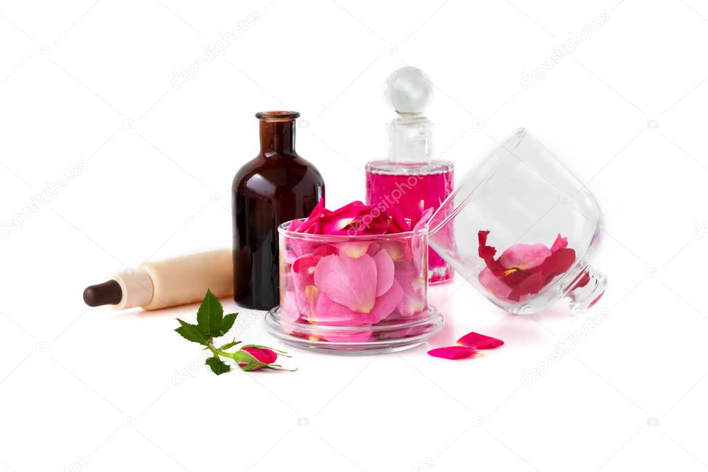 Rose water and rose oil, Petals of Rose damascene on the white background
