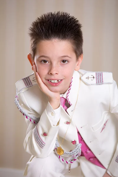 Young boy resting his head on his hand in his First Holy Communi — Stock Photo, Image