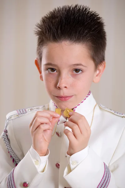 Jongen toont zijn medailles in zijn eerste heilige communie — Stockfoto