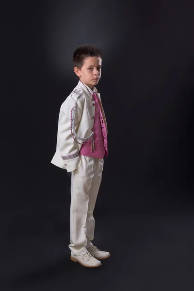 Young boy standing seriously in his First Holy Communion — Stock Photo, Image