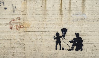 Jerusalem, Israel - 12/15/2019: graffiti on the wall between border of Israel and Palestine, some of them by Banksy