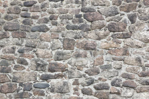 Doğal taşlardan yapılmış antik bir yapının yüzeyi.