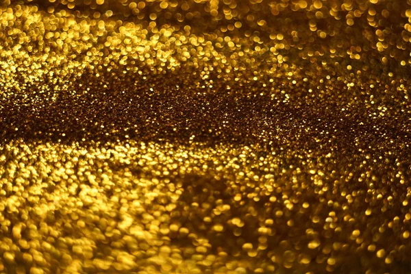 Brilho dourado fundo brilhante, areia dourada textura embaçada . — Fotografia de Stock