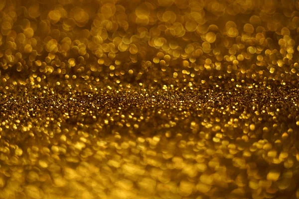 Oro scintillio sfondo sabbioso, oro scintilla trama sfocata . — Foto Stock