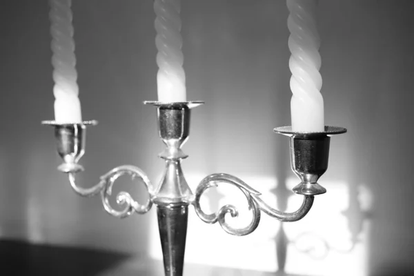 Candlestick with three candles. Shadow reflection on the wall. — Stock Photo, Image