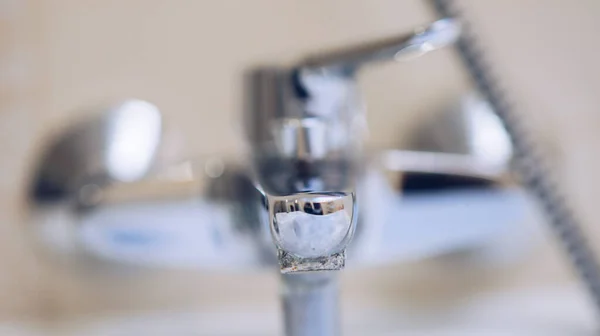 Chrome faucet in the bathroom closeup with lime close, selective focus. — Stock Photo, Image